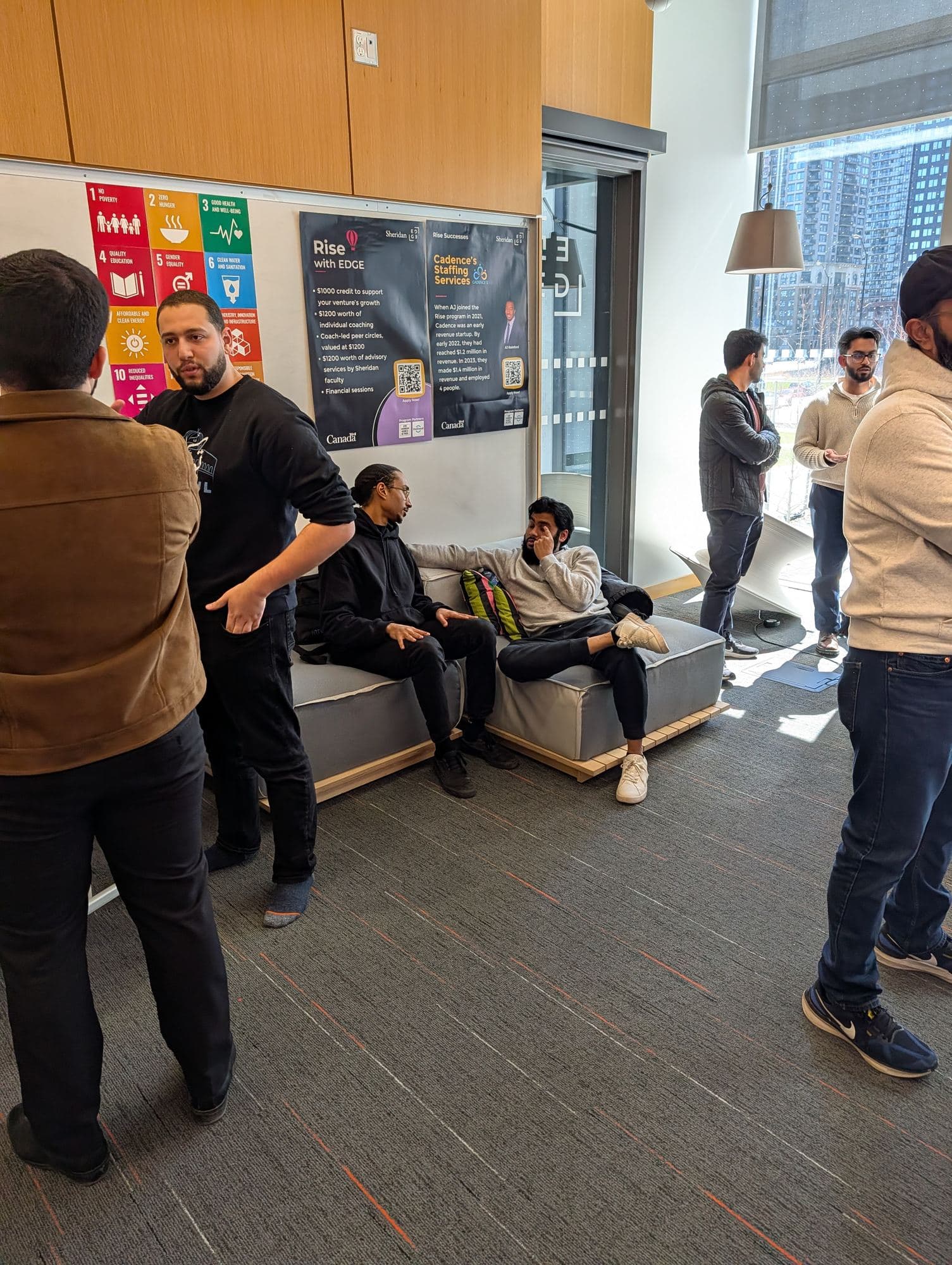 Founders and community members talking in the Sheridan EDGE lounge.
