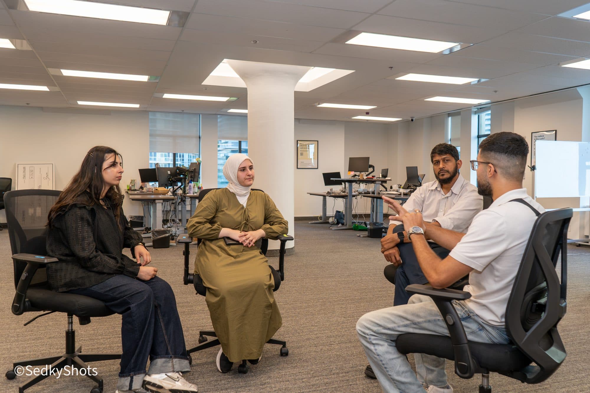 Founders talking in a small circle during a working session.