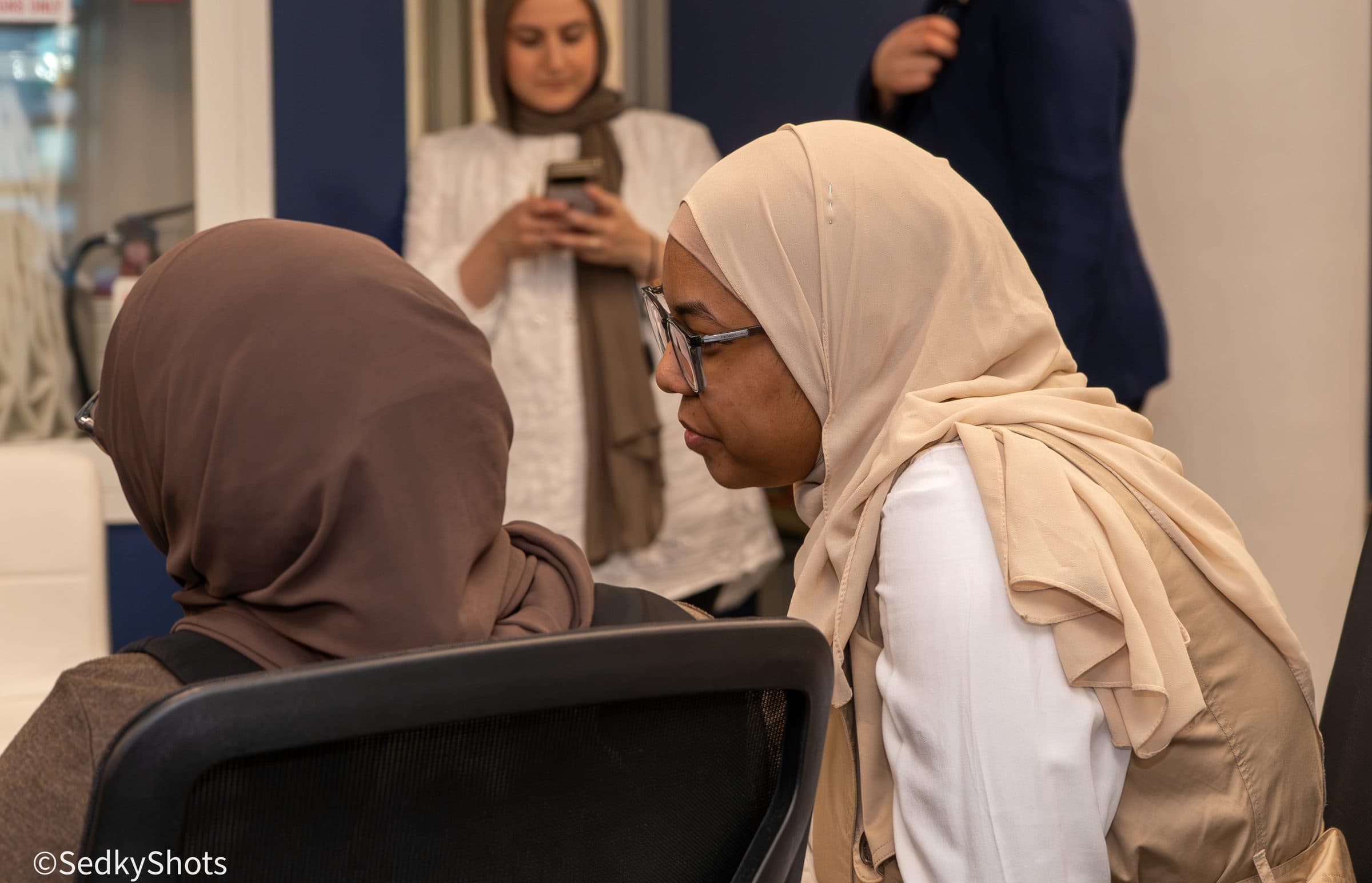 A close working conversation between two people in the room.